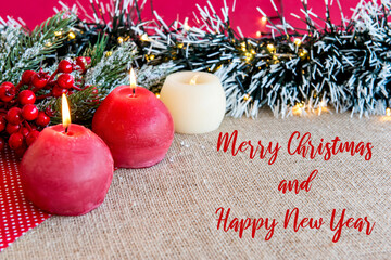 Candles on a Christmas table with Christmas ornaments.