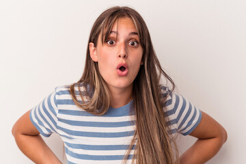 Young caucasian woman isolated on white background being shocked because of something she has seen.