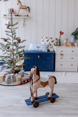 Scandinavian Style Blue Christmas Tree in Kids Room with Party Toys Vintage Wooden Horse