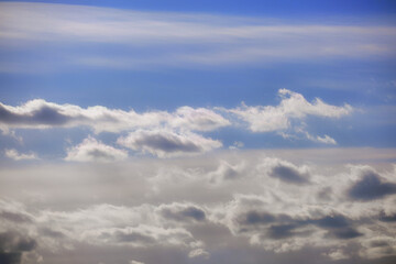 Naklejka na ściany i meble Blue sky background with dark clouds in winter evening