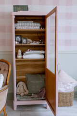 Obraz na płótnie Canvas Pink baby closet for linen in the Scandinavian-style room Toy hare