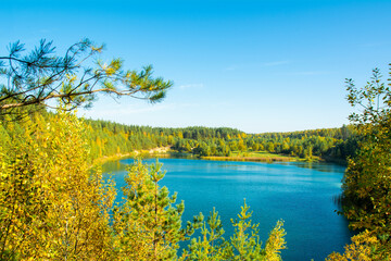 Fototapeta na wymiar splendid view of a calm lake and autumn forest on a sunny day. location place of Luban, Belarus, Europe. beauty of earth. natural wallpaper.