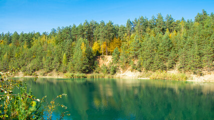panorama view of fall colors reflecting on the surface of a lake - park, Belarus
