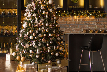 Christmas tree with gold and copper decorations in a dark bar room