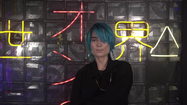 Anime fan, young attractive man with katana sword. Japanese anime cosplay. Inscription on the background in Japanese: path from darkness to light