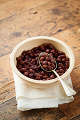 Cooked beans red canned food ready to eat healthy meal portion on wooden background, copy space.