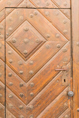 Fototapeta premium Old door with an interesting ornament, close-up.