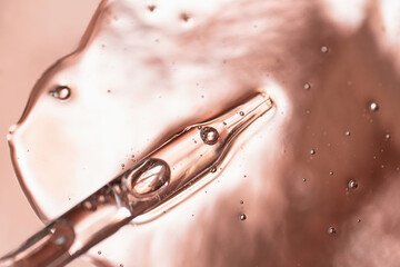 Pipette from dropper in the cosmetics gel.Top view,liquid cosmetic,macro photography.Beautiful...