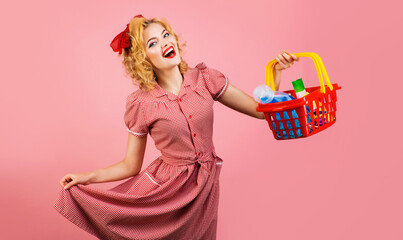 Shopping. Happy girl with shopping basket in supermarket. Store. Sale. Discount. Buying. Advertising.