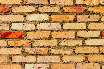 Texture of a brick wall with cracks and scratches which can be used as a background