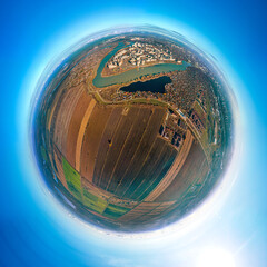 little planet panorama over rice paddies and fields near the Kuban River on the western outskirts of Krasnodar (southern Russia) at the sunny end of a late autumn day