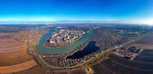 Yubileiny microdistrict of the city of Krasnodar on the bend of the Kuban River and Lake Brzegokai - a large aerial panorama on a sunny day in late autumn - obrazy, fototapety, plakaty