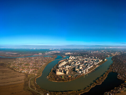 Yubileiny microdistrict of the city of Krasnodar on the bend of the Kuban River - a large aerial panorama on a sunny day in late autumn