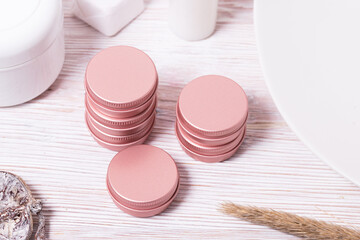 Set of small tin metal cases for cosmetic on wooden table