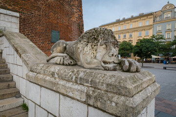 A statue of a lion as a decorative element in front of the stairs, close-up of the object.