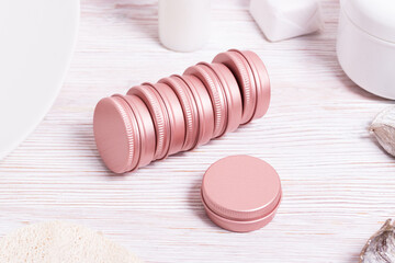 Set of small tin metal cases for cosmetic on wooden table