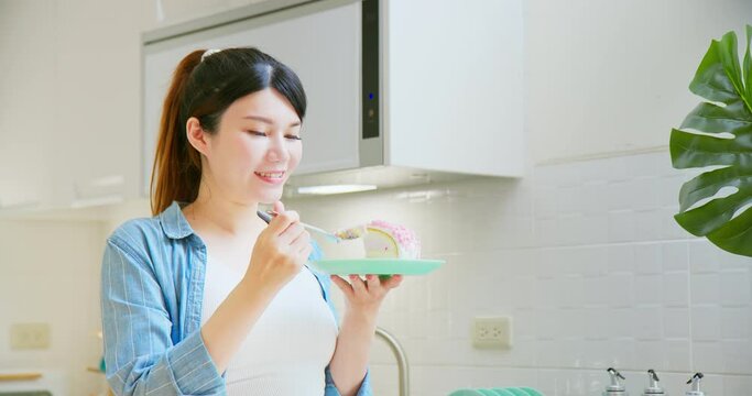 Asian pregnant woman eat cake
