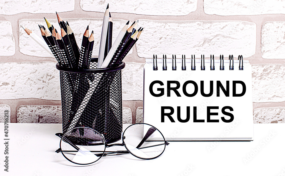 Poster a workplace in the house with glasses, pencils in a stand and a notebook with text ground rules on a