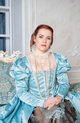 Beautiful young woman in medieval style blue dress