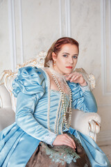 Beautiful young woman in medieval style blue dress