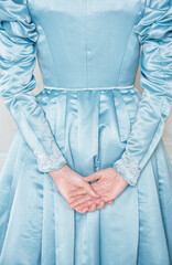 Hands of woman in beautiful medieval dress back pose.