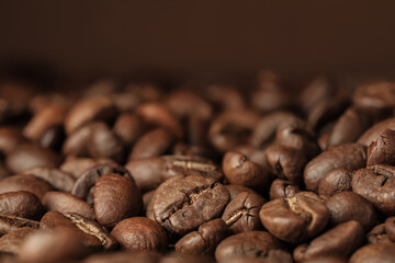 Heap of aromatic roasted coffee beans, closeup