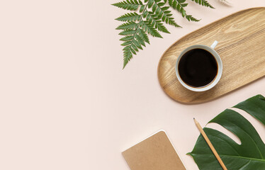 Tropical workspace concept. Notepad and tropical palm leaves. Mockup presentation workplace.