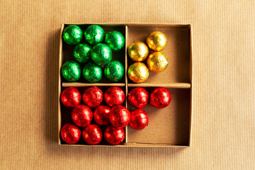 Colorful round chocolate candy in the box, top view