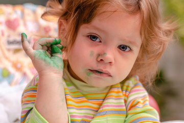 The concept of children's creativity. Dirty baby painting