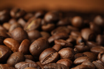 Heap of aromatic roasted coffee beans, closeup