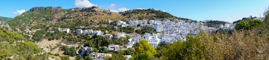 Fototapeta na wymiar Typical spanish mountain village with its narrow white buildings in Andalusia in summertime