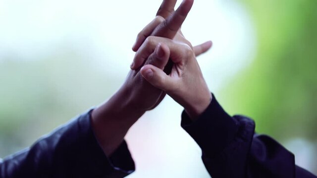 Two diverse hands in unon and support, two people joining forces