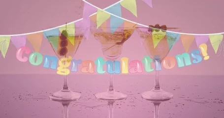 Keuken foto achterwand Image of congratulation text and bunting over three cocktail glasses on pink background © vectorfusionart