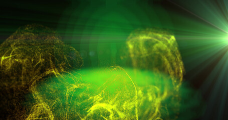 Image of yellow particles moving in green light on black background