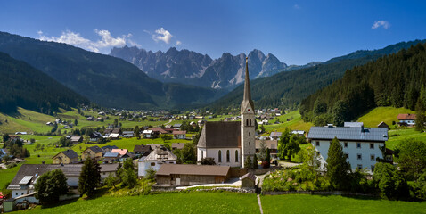 Fototapeta na wymiar Church on top of hill near beautiful mountains view