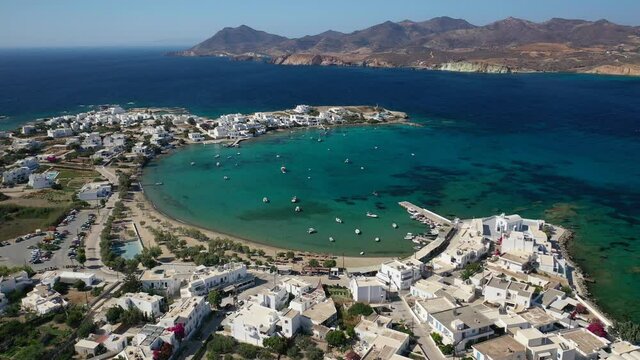Aerial drone rotational video of picturesque fishing village of Polonia with traditional fishing boats anchored next to island of Kimolos, Milos island, Cyclades, Greece