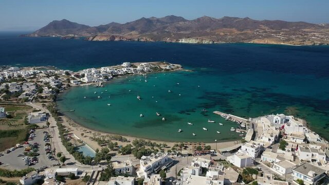Aerial drone rotational video of picturesque fishing village of Polonia with traditional fishing boats anchored next to island of Kimolos, Milos island, Cyclades, Greece