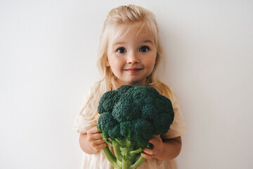 Child girl with broccoli organic vegetable food healthy lifestyle vegan menu plant based diet...