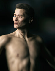 Fototapeta premium Shirtless athletic asian man. Low key studio portrait. 3D rendering.