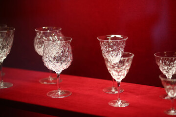 Set of crystal wine or champagne glasses on red velvet background