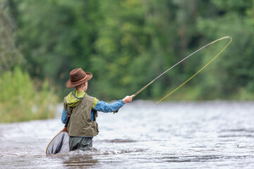 child fishing on the river