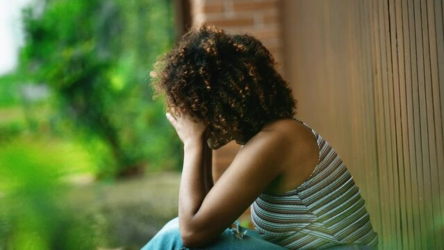 Victim woman covering face with hands feeling shame and loneliness