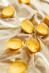 Yellow whole and sliced lemons. Isometric view of a minimal still life.