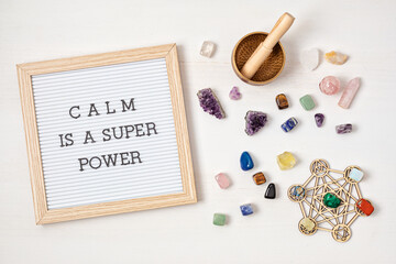Letter board with motivation text calm is a super power. Gemstones, crystals for megitation and...