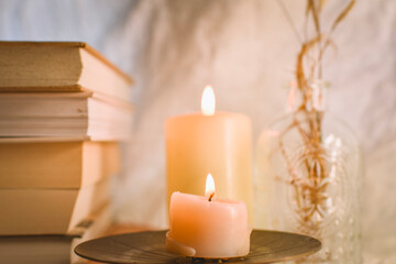 stack of old books and candles 