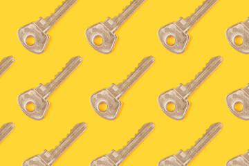 Background made from different metal keys on the yellow base, top view