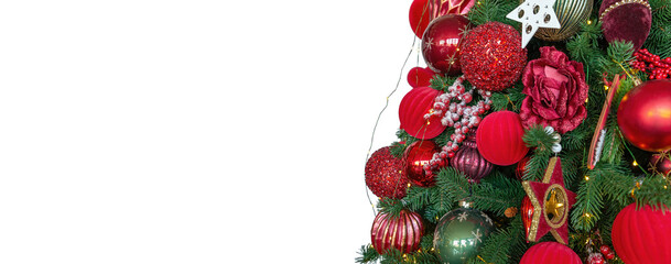 Fototapeta na wymiar Background with decorated part of Christmas tree isolated on white background. Red balls, ribbons, stars on the branch. Empty space for your text. New Year and Christmas concept. Banner.