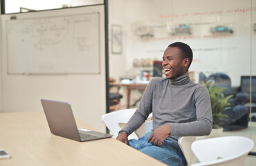 happy young man in front of a computer