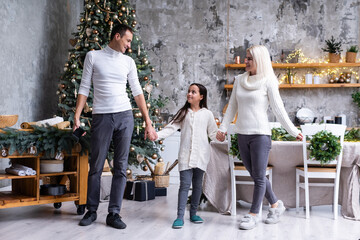 family, christmas, x-mas, winter, happiness and people concept - smiling family Preparing to celebrate Christmas.