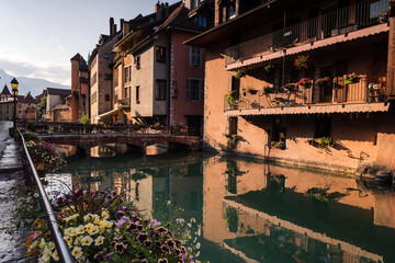 Medieval old town streets of Annecy and the reflection of the buildings in the water of the canal, France